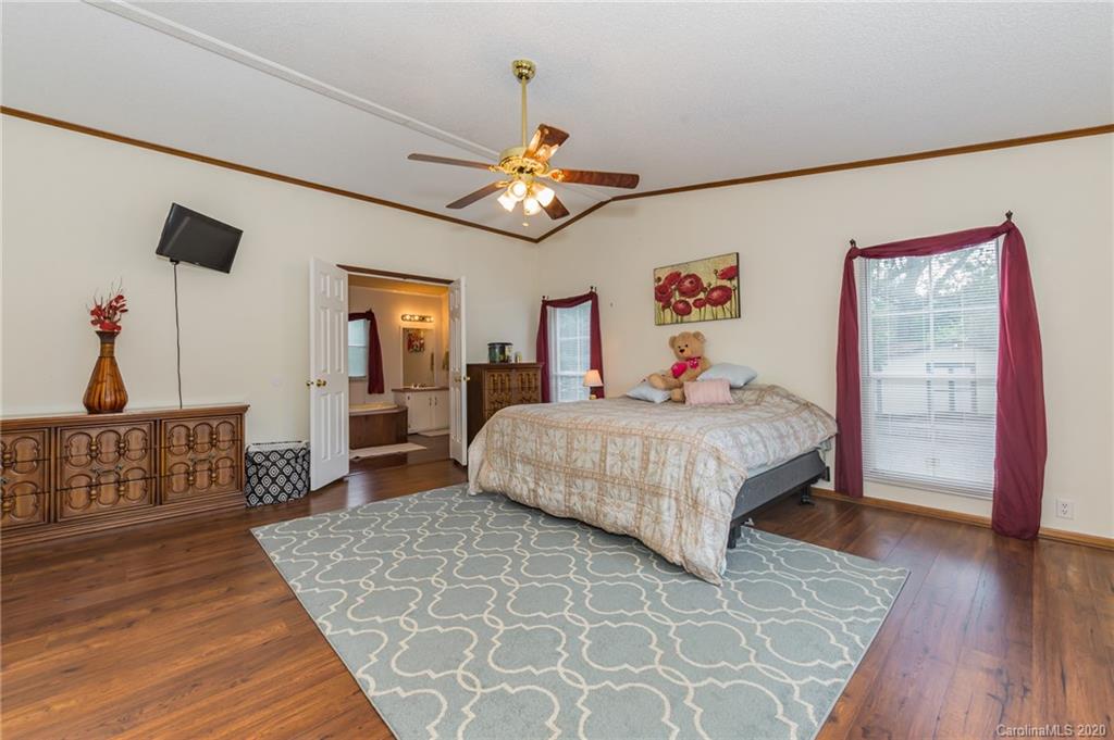 265 Pinecone Road Peachland, NC 28133 - Photo 12 of 35 a bedroom with a bed and wooden floor
