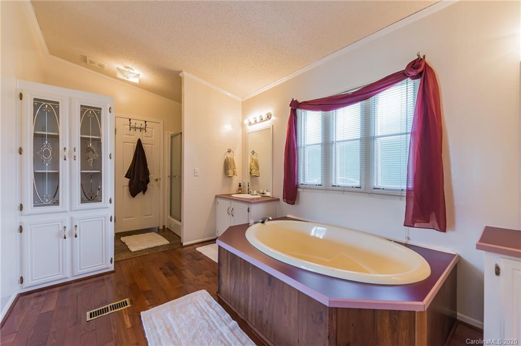 265 Pinecone Road Peachland, NC 28133 - Photo 14 of 35 a bathroom with a tub a sink and a mirror