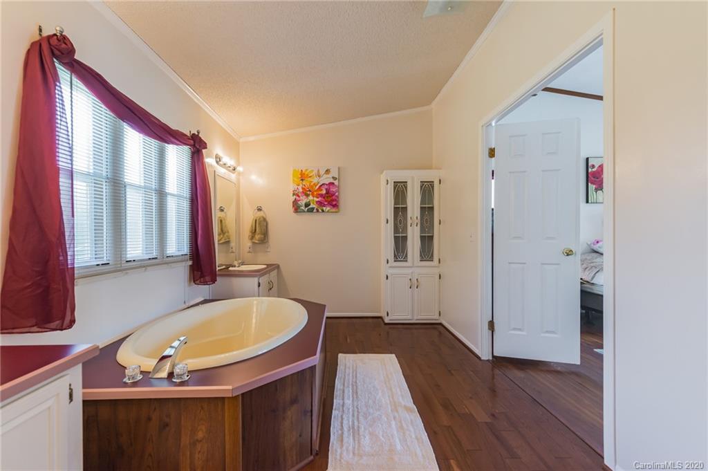 265 Pinecone Road Peachland, NC 28133 - Photo 15 of 35 a bathroom with a tub sink and mirror