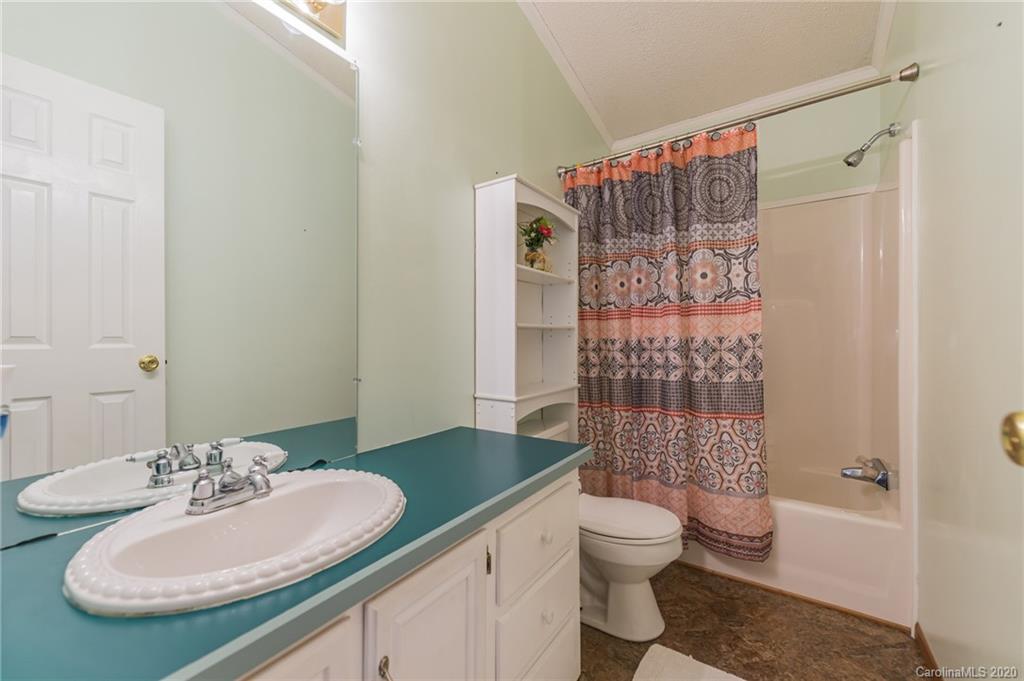 265 Pinecone Road Peachland, NC 28133 - Photo 19 of 35 a bathroom with a granite countertop sink toilet and shower