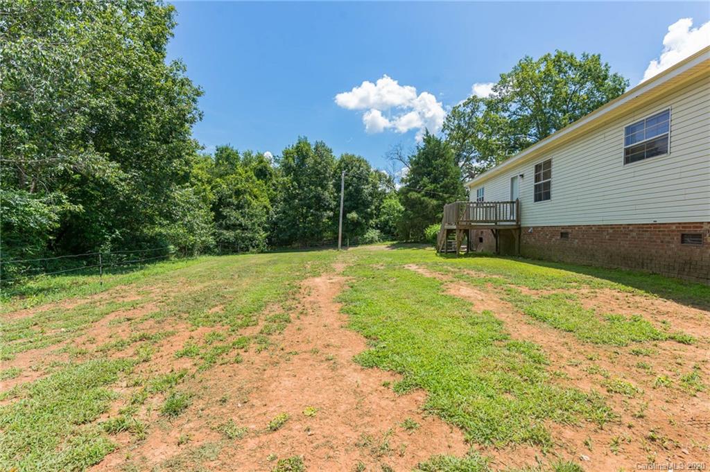 265 Pinecone Road Peachland, NC 28133 - Photo 24 of 35 a backyard of a house with lots of green space