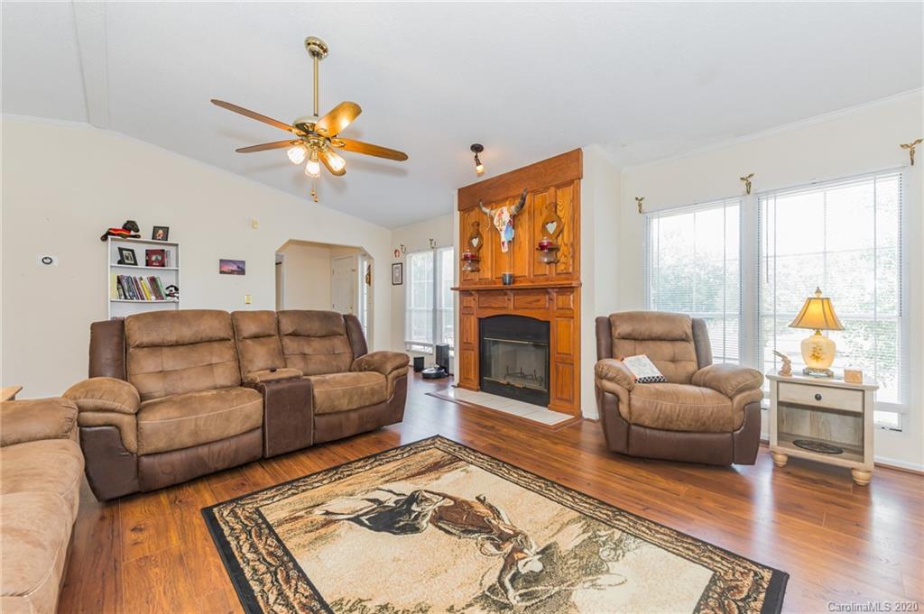 265 Pinecone Road Peachland, NC 28133 - Photo 5 of 35 a living room with furniture a fireplace and a flat screen tv