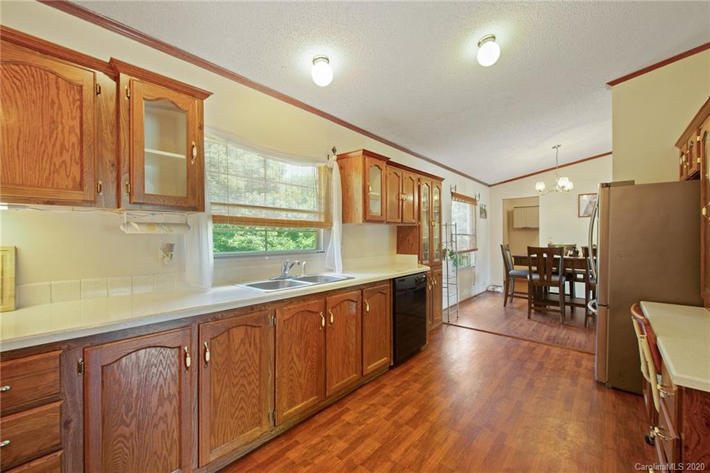 265 Pinecone Road Peachland, NC 28133 - Photo 9 of 35 a kitchen with stainless steel appliances granite countertop a stove a sink and a refrigerator