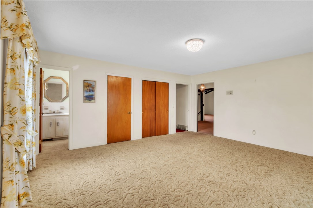 491 City Lake Road Pickens, SC 29671 - Photo 11 of 32 This carpeted room features warm wooden doors and an inviting entrance to an adjacent space.
