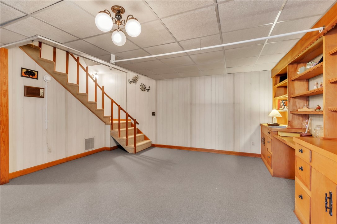 491 City Lake Road Pickens, SC 29671 - Photo 17 of 32 This versatile basement space features built-in shelving, perfect for a home office or recreation area.