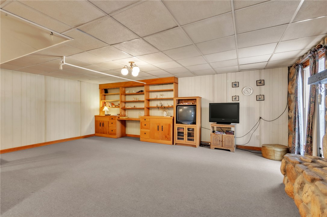 491 City Lake Road Pickens, SC 29671 - Photo 18 of 32 This versatile basement space features built-in shelving, offering endless possibilities for recreation or a home office.