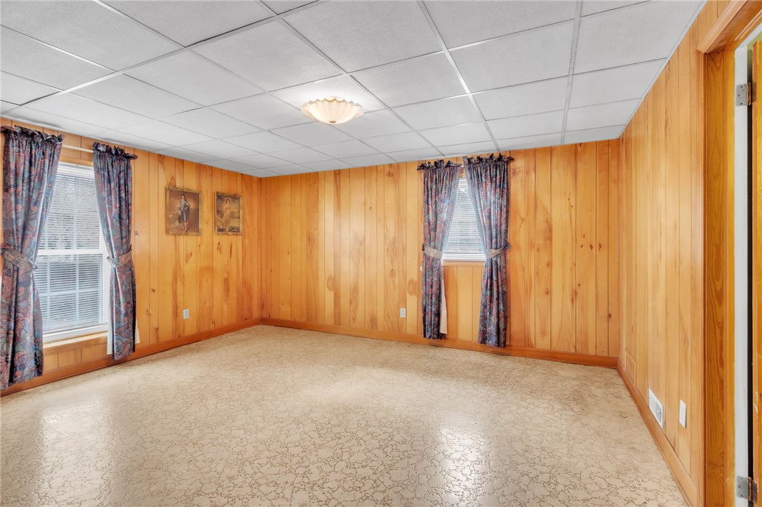 491 City Lake Road Pickens, SC 29671 - Photo 23 of 32 This versatile room features warm wood paneling, offering a cozy and adaptable living space.