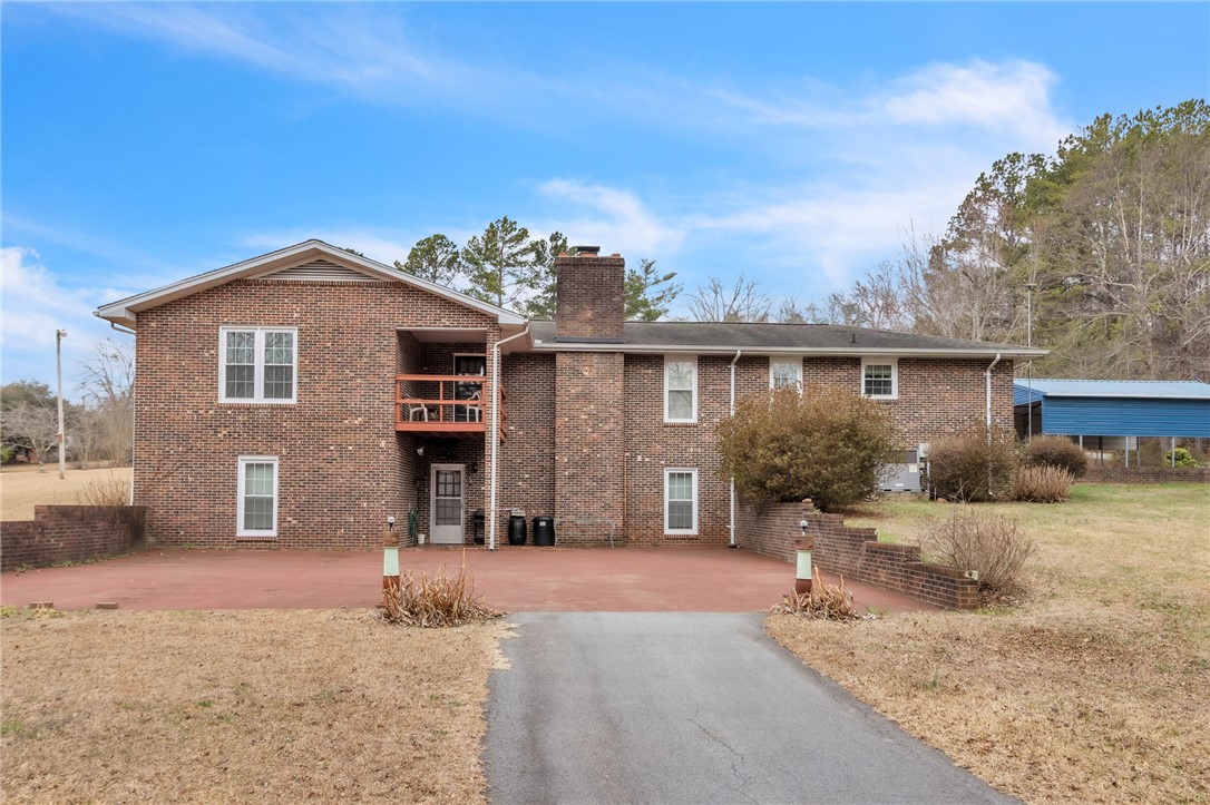 491 City Lake Road Pickens, SC 29671 - Photo 3 of 32 This classic brick residence features an upper-level balcony and a welcoming front entrance.