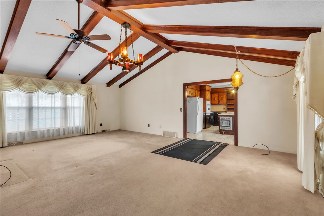 491 City Lake Road Pickens, SC 29671 - Photo 32 of 32 This spacious living area features high vaulted ceilings and an open floor plan, seamlessly connecting to the kitchen.