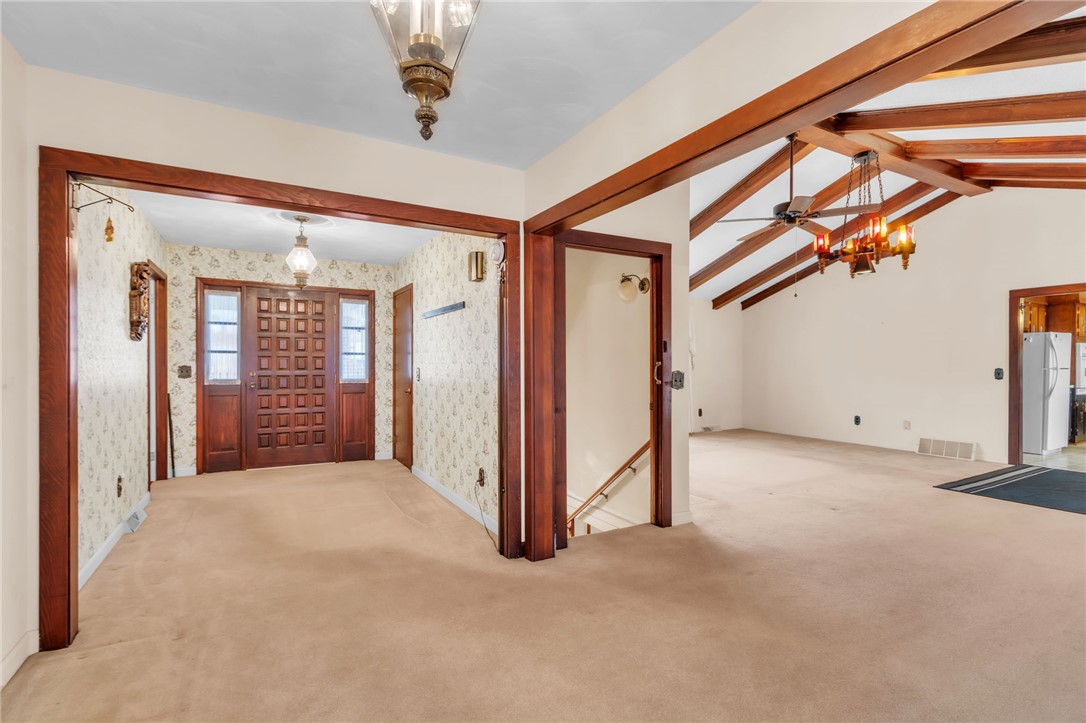 491 City Lake Road Pickens, SC 29671 - Photo 6 of 32 This interior entryway features high ceilings, an elegant chandelier, and rich wood accents.