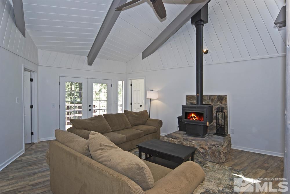 190 Pinon Road Markleeville, CA 96120 - Photo 13 of 31 a living room with furniture a fireplace and a floor to ceiling window
