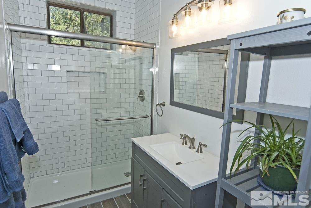 190 Pinon Road Markleeville, CA 96120 - Photo 16 of 31 a bathroom with a sink a mirror and a shower