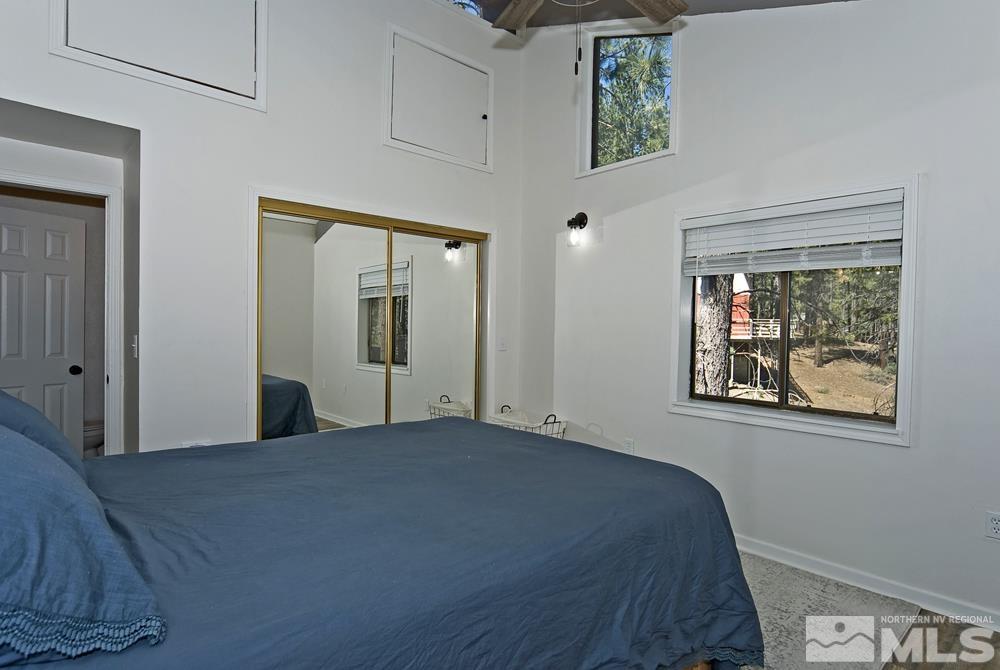 190 Pinon Road Markleeville, CA 96120 - Photo 18 of 31 a view of a bedroom with wooden floor and windows