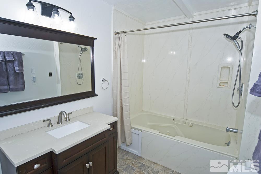 190 Pinon Road Markleeville, CA 96120 - Photo 23 of 31 a bathroom with a tub sink mirror and a shower
