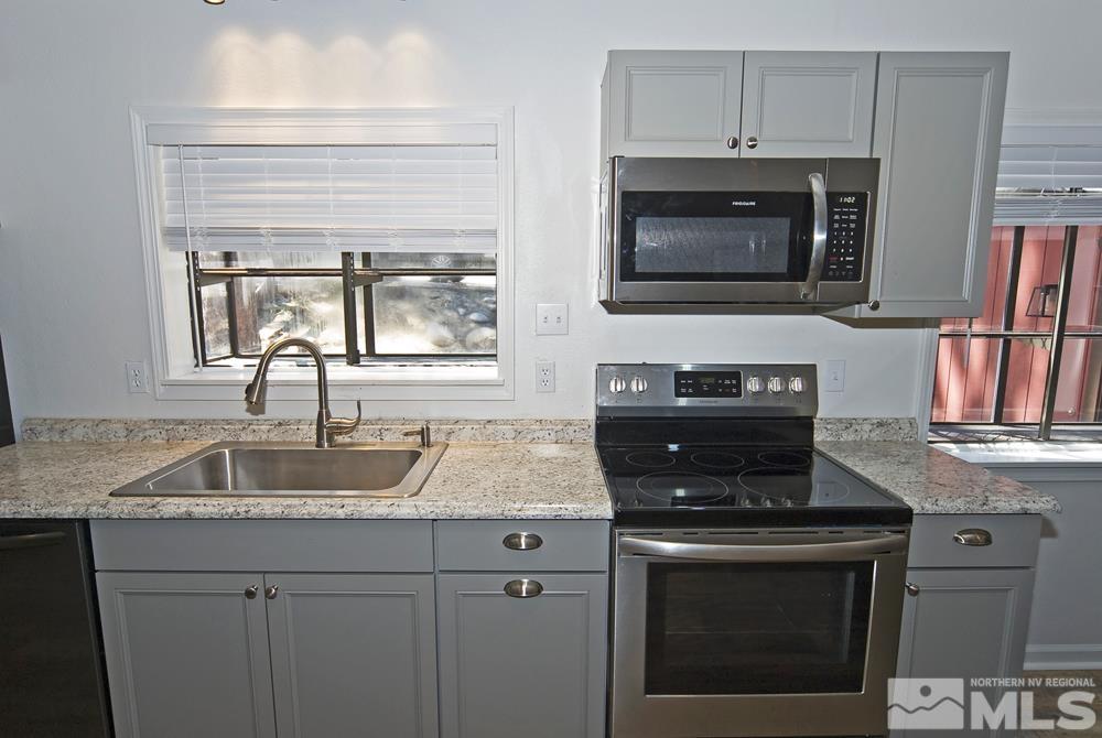 190 Pinon Road Markleeville, CA 96120 - Photo 10 of 31 a kitchen with granite countertop a stove sink and microwave