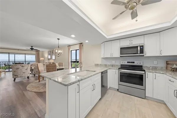 a kitchen with a sink stove and microwave