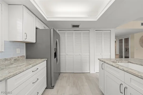 a kitchen with granite countertop cabinets stainless steel appliances and a counter space