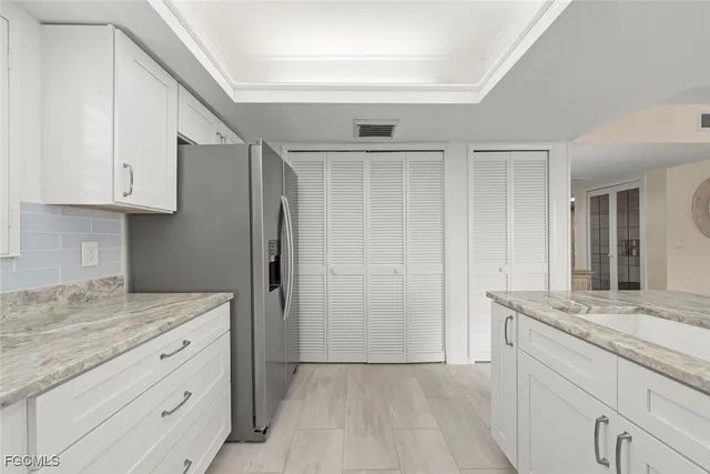 a kitchen with granite countertop cabinets stainless steel appliances and a counter space