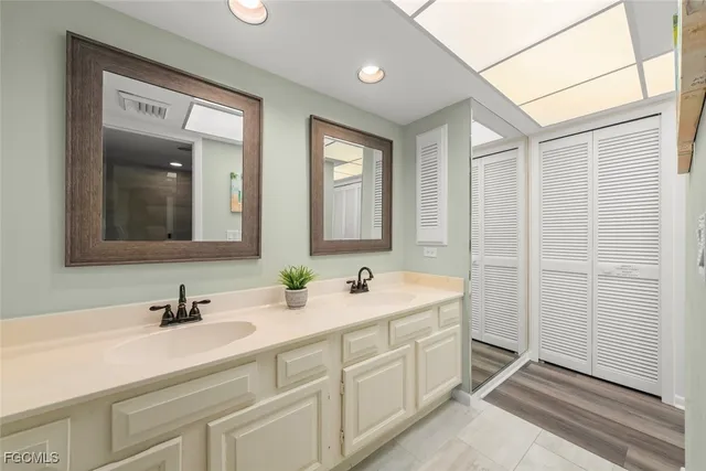 a bathroom with a double vanity sink mirror and