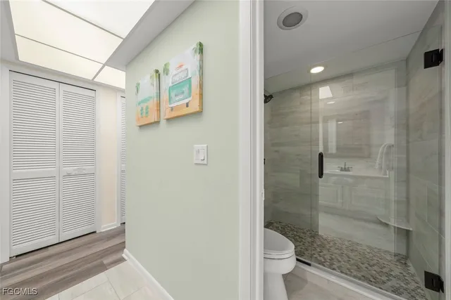 a bathroom with a shower and toilet