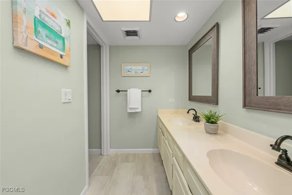 a bathroom with a sink and a large mirror