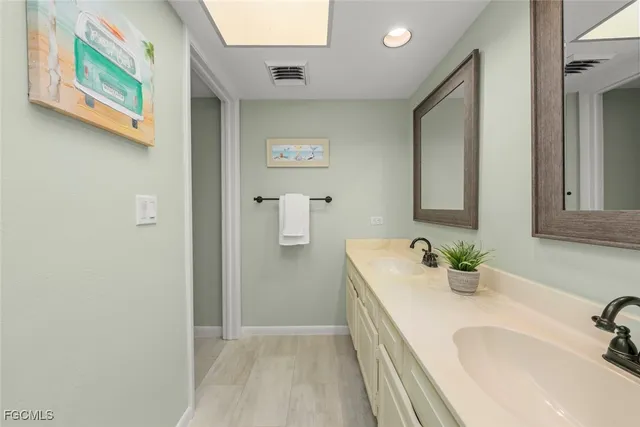 a bathroom with a sink and a large mirror