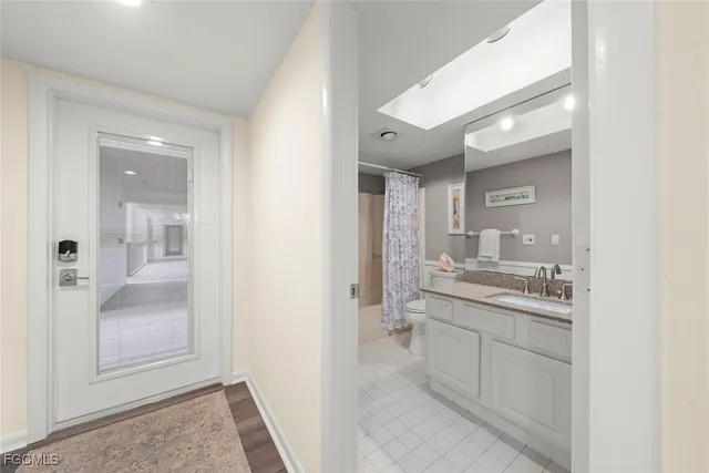 a bathroom with a granite countertop sink mirror and bathtub