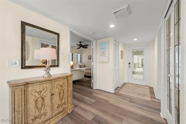 a view of a room that has a bed and a mirror in it