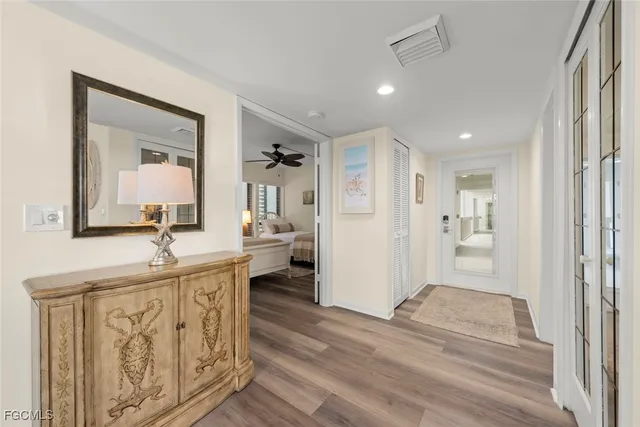 a view of a room that has a bed and a mirror in it