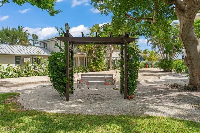 a view of a white house with a yard