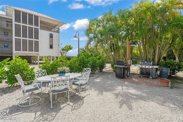 a view of a patio with a table and chairs and potted plants