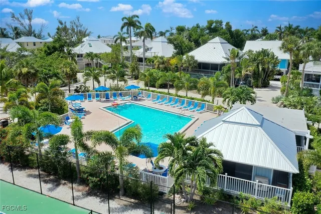an aerial view of a house with swimming pool patio and outdoor seating