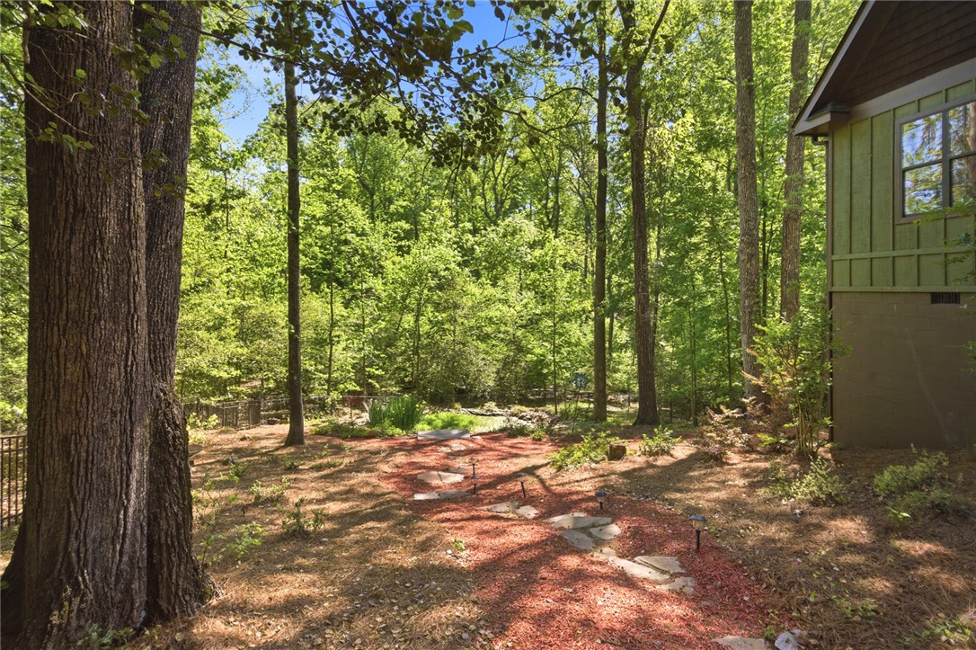 215 Inlet Pointe Drive Anderson, SC 29625 - Photo 42 of 47 A tranquil pathway winds through a lush, verdant yard, offering serene natural beauty.