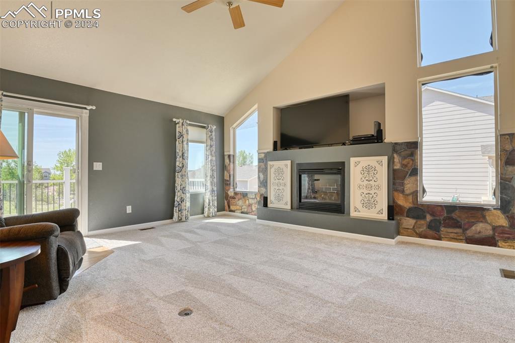 7863 Buschborn Road Peyton, CO 80831 - Photo 13 of 50 a view of an empty room with furniture and a fireplace