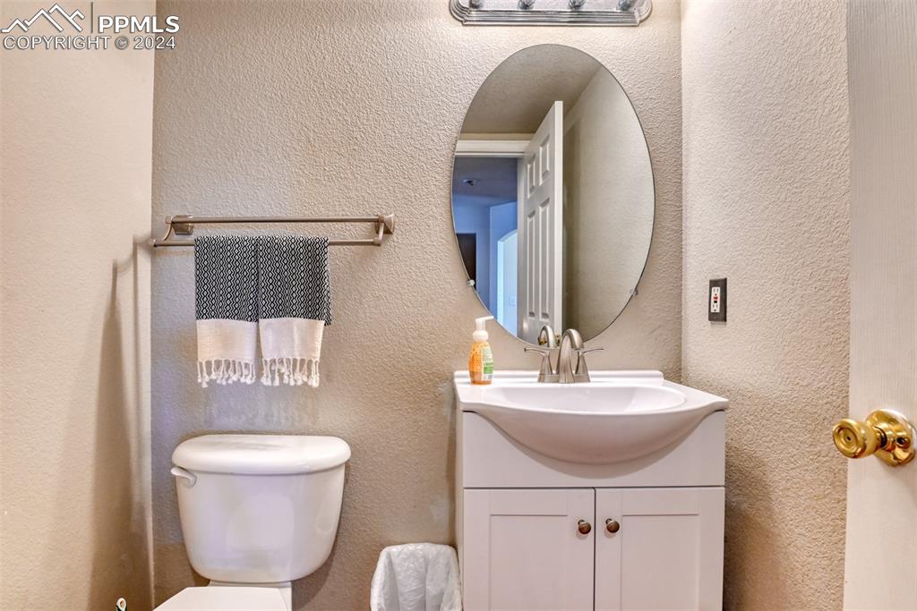 7863 Buschborn Road Peyton, CO 80831 - Photo 16 of 50 a bathroom with a toilet sink and mirror