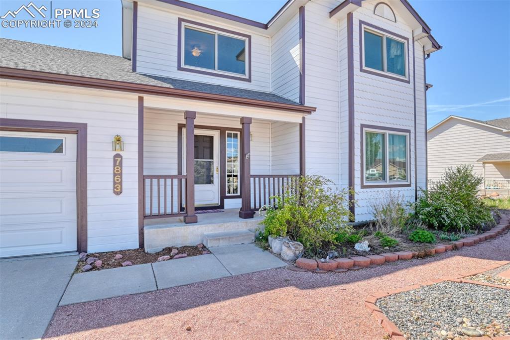 7863 Buschborn Road Peyton, CO 80831 - Photo 2 of 50 a front view of a house with garden