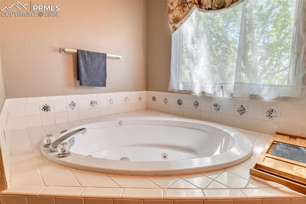 7863 Buschborn Road Peyton, CO 80831 - Photo 23 of 50 a bathroom with a bathtub and a window
