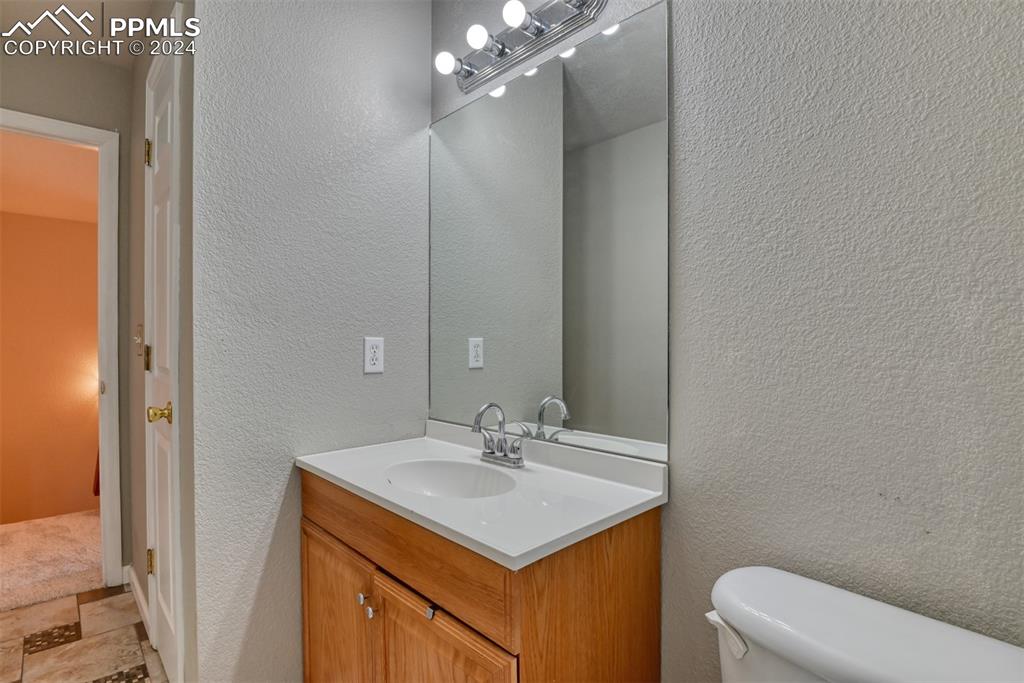 7863 Buschborn Road Peyton, CO 80831 - Photo 26 of 50 a bathroom with a sink vanity and a mirror