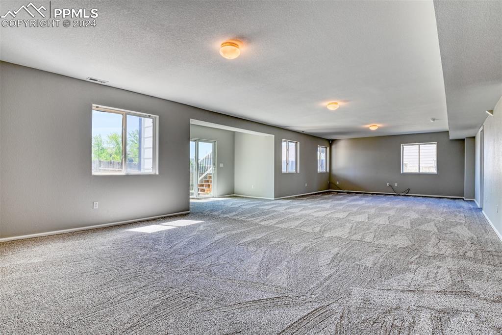 7863 Buschborn Road Peyton, CO 80831 - Photo 34 of 50 an empty room with windows and mirror