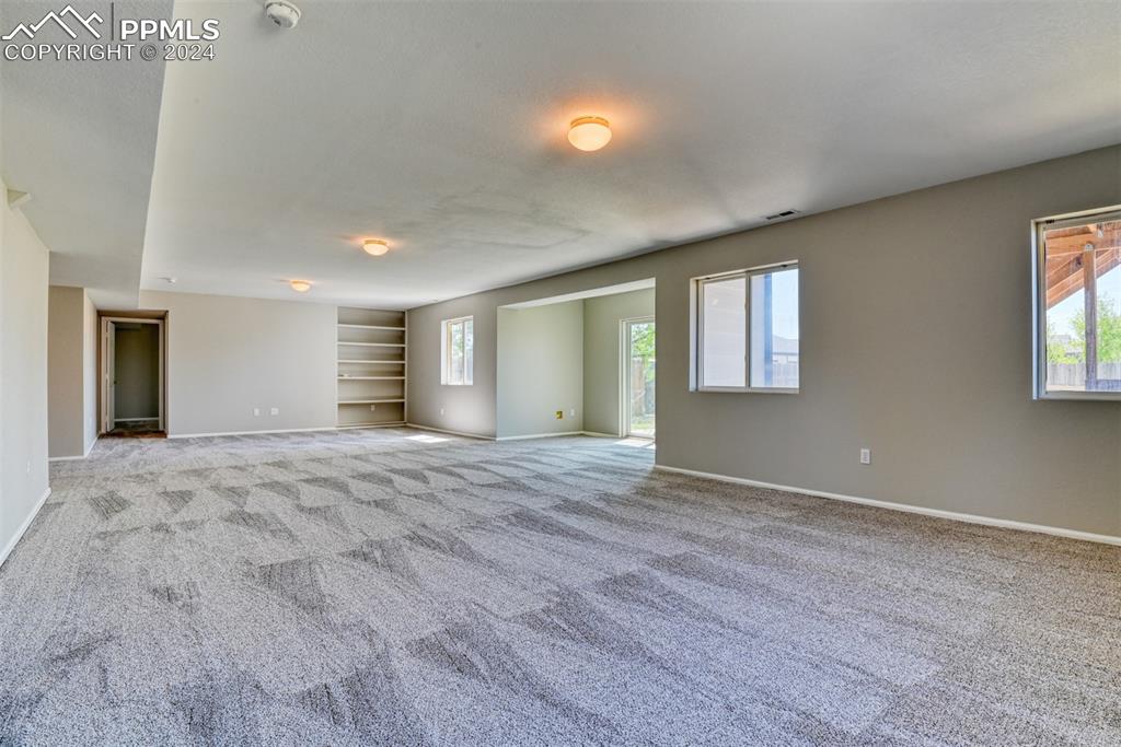 7863 Buschborn Road Peyton, CO 80831 - Photo 37 of 50 a view of an empty room with window and wooden floor