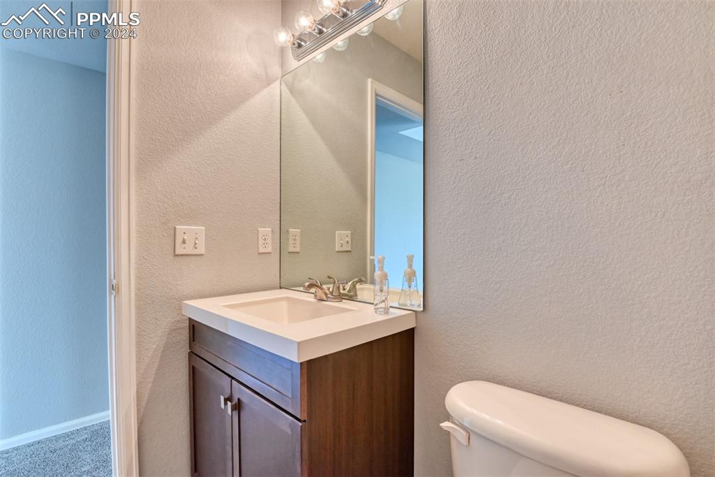 7863 Buschborn Road Peyton, CO 80831 - Photo 41 of 50 a bathroom with a sink a toilet and mirror