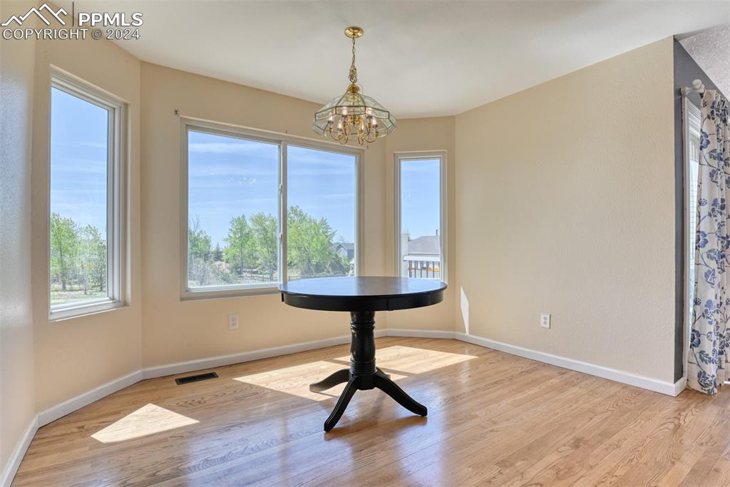 7863 Buschborn Road Peyton, CO 80831 - Photo 8 of 50 a view of an empty room with wooden floor and a window