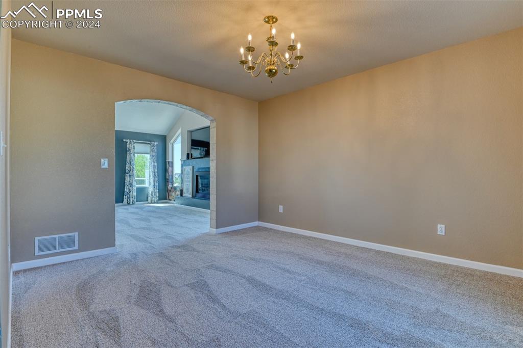 7863 Buschborn Road Peyton, CO 80831 - Photo 10 of 50 a view of a hallway with a chandelier