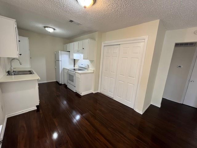 8127 Stonehurst Street, Unit 5 Dallas, TX 75217 - Photo 3 of 11 a kitchen with a sink and wooden floor