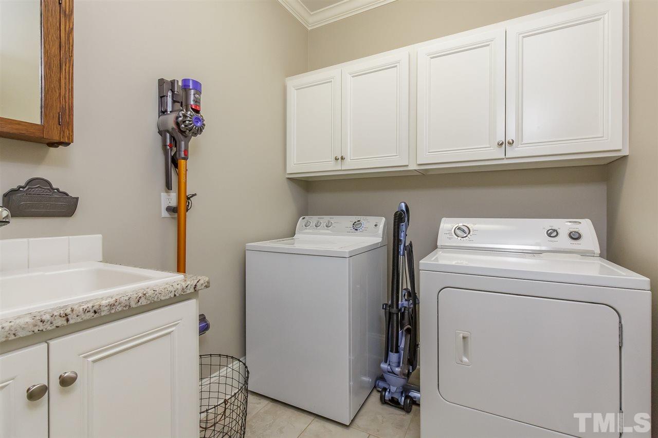 2514 Rogers Road Graham, NC 27253 - Photo 18 of 30 Laundry room is located just outside the master and has granite utility sink and built-in upper cabinets
