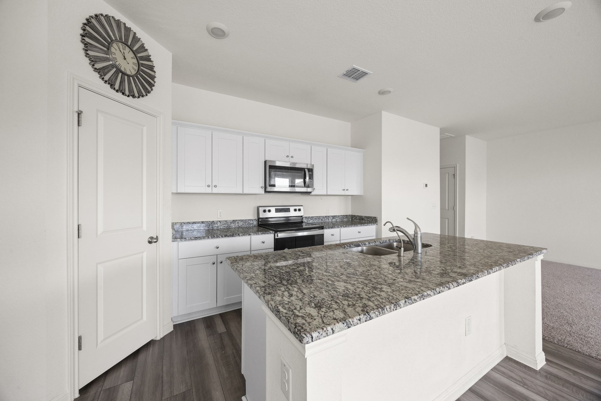 410 Magnum Force Drive Jarrell, TX 76537 - Photo 15 of 32 a kitchen with granite countertop a sink a stove and cabinets