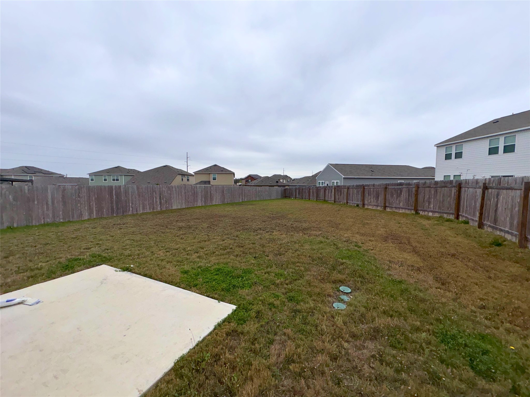 410 Magnum Force Drive Jarrell, TX 76537 - Photo 17 of 18 Fenced backyard featuring a residential view and a patio area