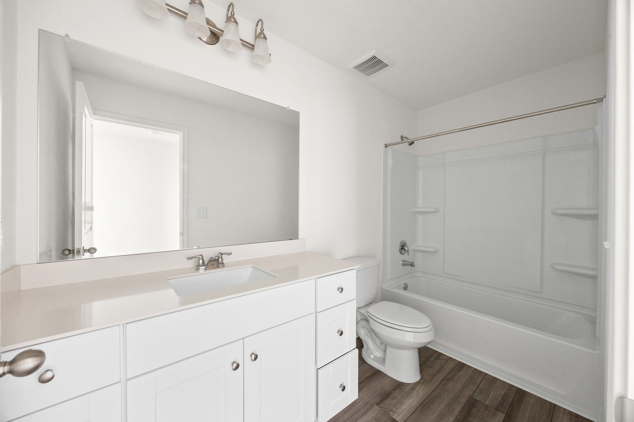 410 Magnum Force Drive Jarrell, TX 76537 - Photo 26 of 32 a bathroom with a toilet a sink a mirror and a bathtub