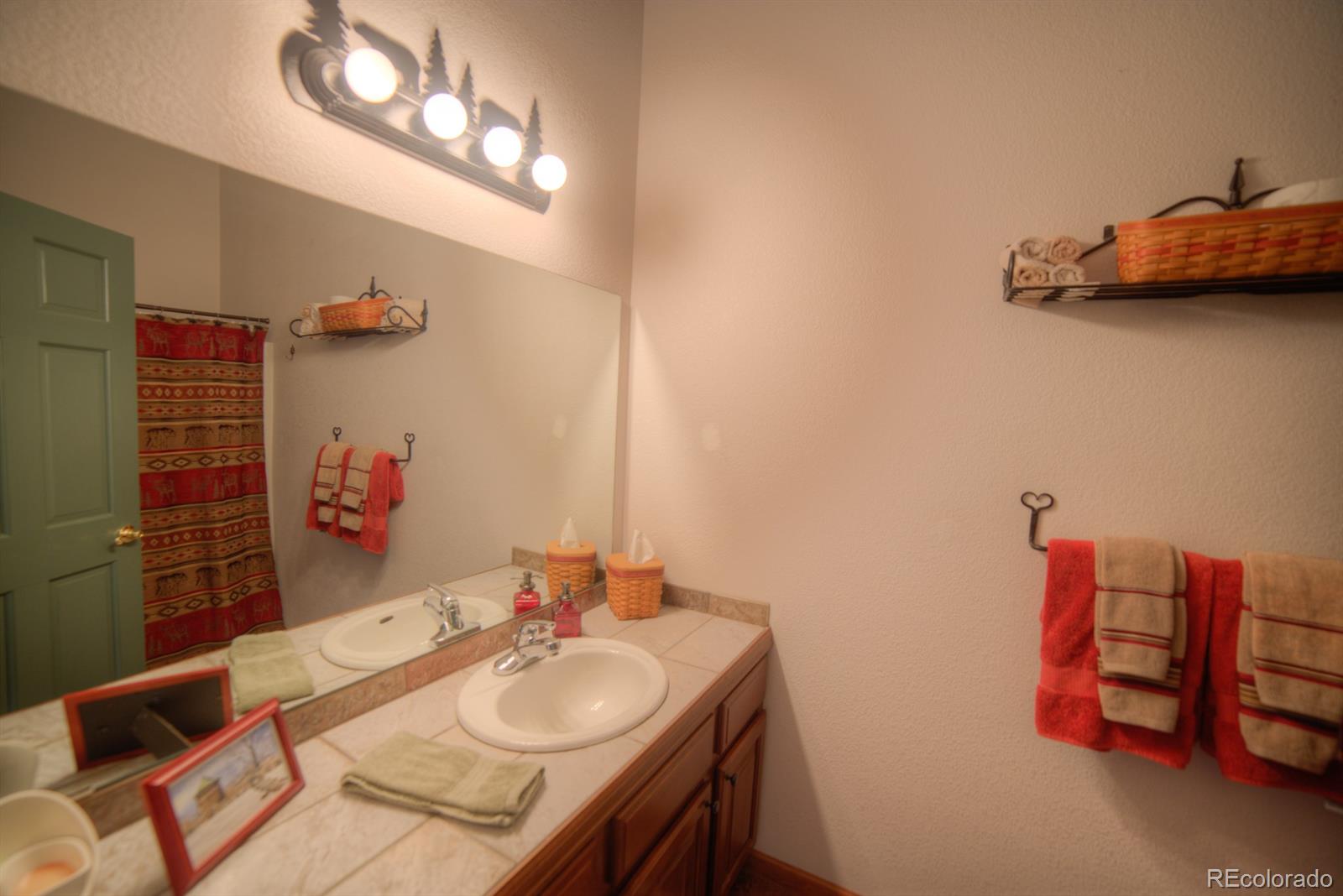 264 Hangmans Road Bailey, CO 80421 - Photo 15 of 33 a bathroom with a sink and a mirror