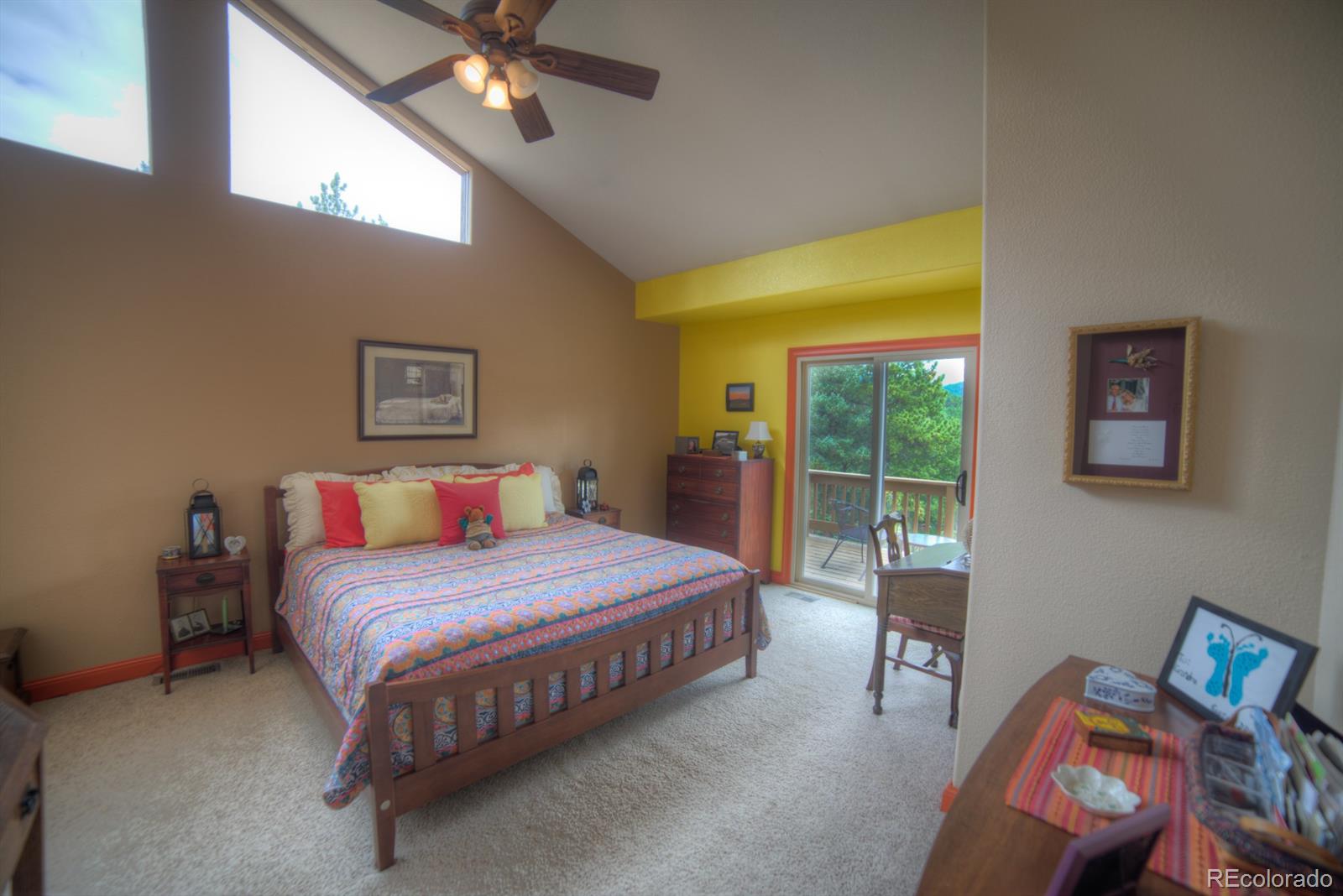 264 Hangmans Road Bailey, CO 80421 - Photo 16 of 33 a bedroom with a bed and a chandelier